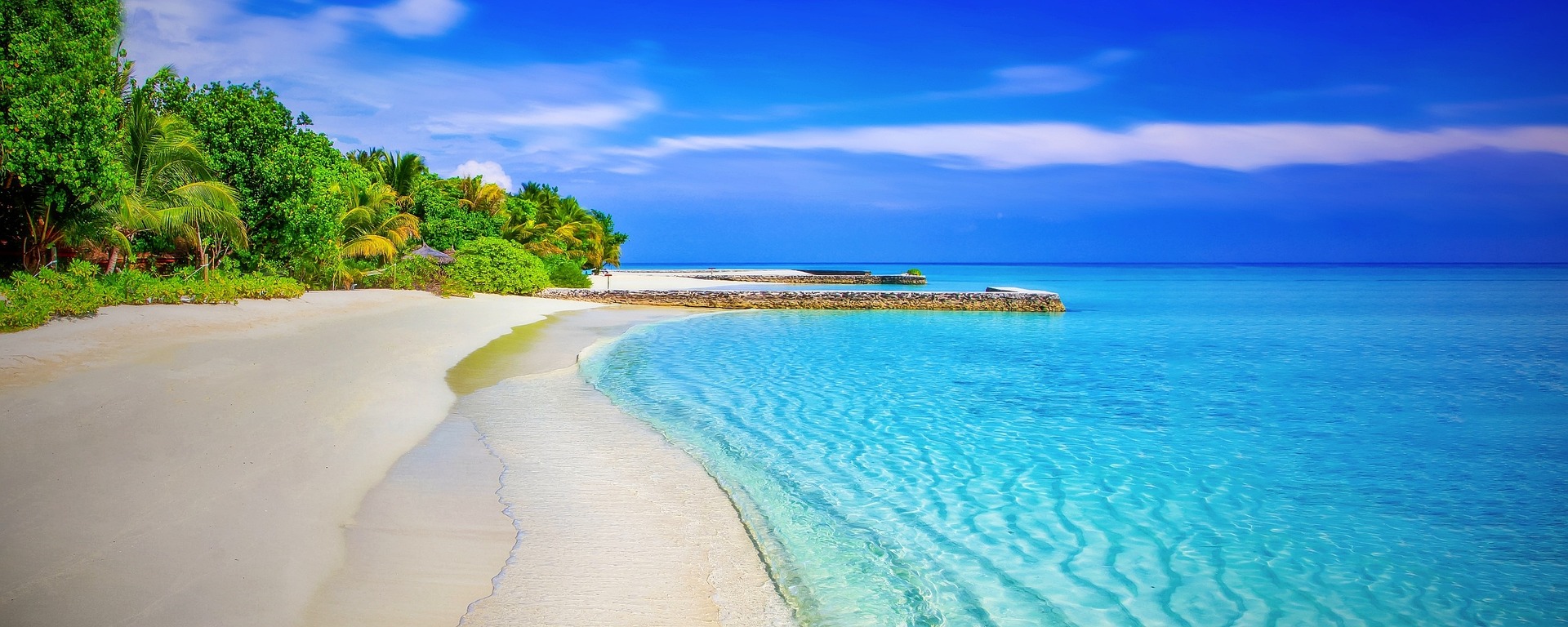 Urlaub im November Ein menschenleerer tropischer Strand mit Palmen